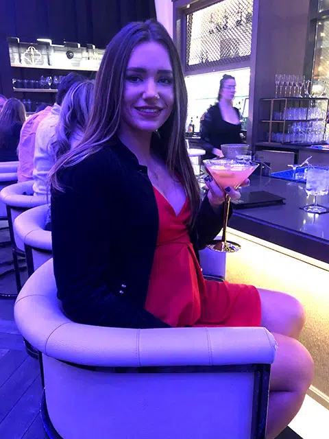 rachel hannah sitting at one of the bars inside of the amway plaza hotel in grand rapids, michigan
