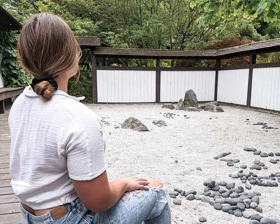 rachel  hannah sitting inside the zen garden at the horticulture gardens in east lansing, michigan