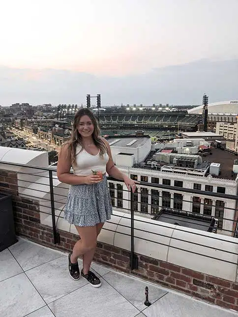 rachel hannah with a cocktail on the monarch club rooftop 