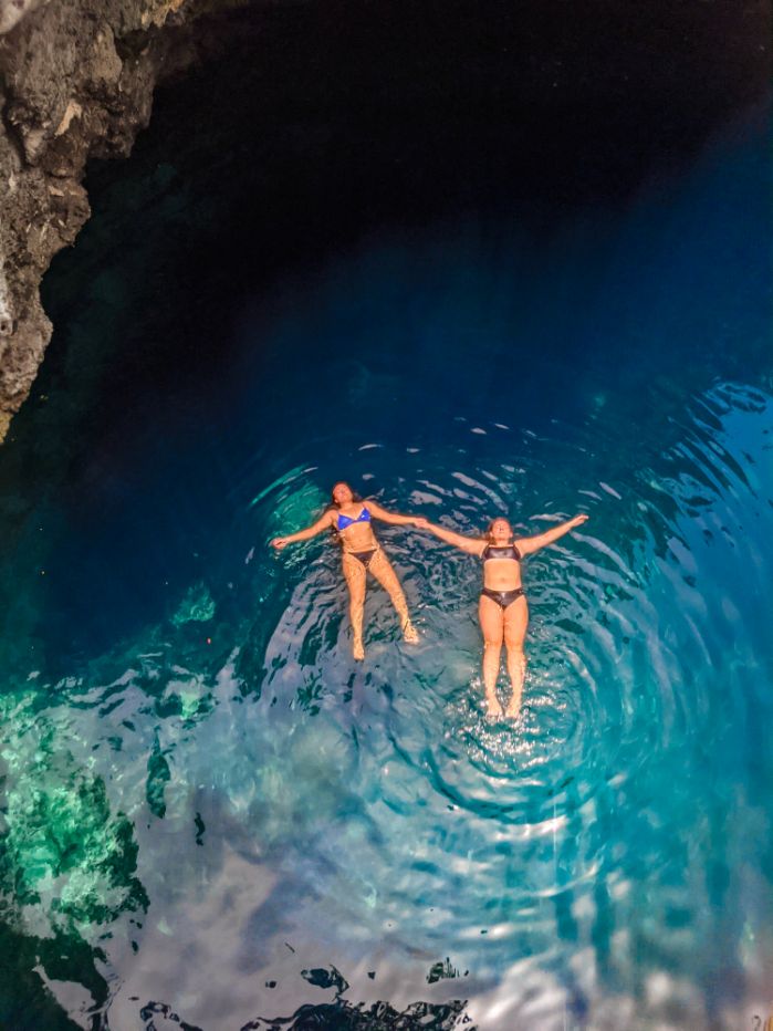 eleuthera blue hole ariel view of two girls floating