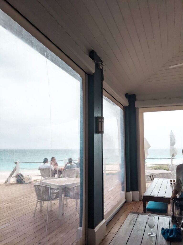 dining room with clear sliding screen on rainy day at blue bar pink sands resort on harbour island