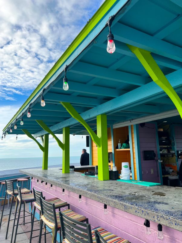 pink green and turquoise st pete beach rooftop bars overlooking ocean with a view