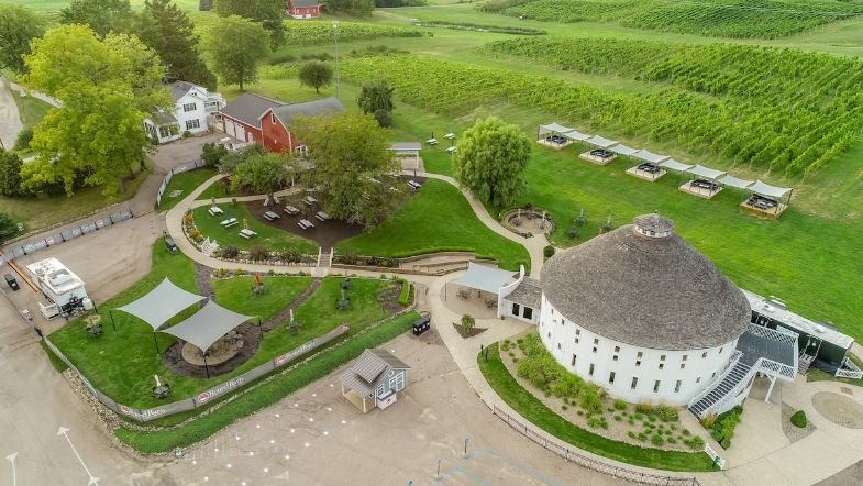 sky view of a round barn house and vineyard property. One of the unique airbnbs in Michigan