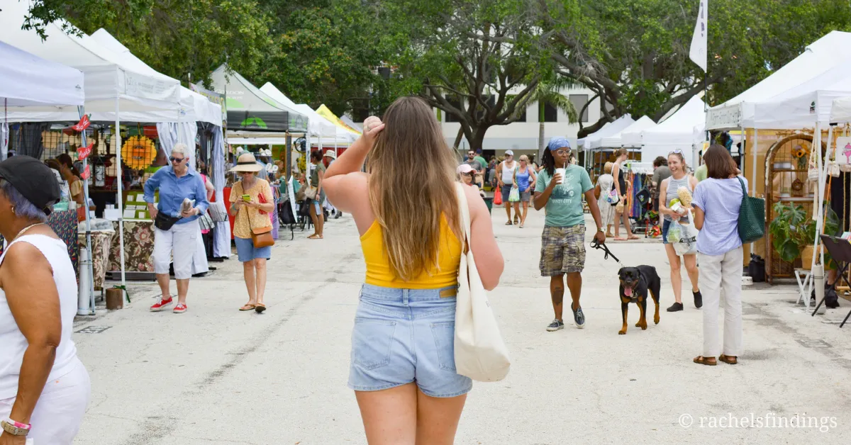 girl in yellow top jean shorts and tote checking out the weekend in st Petersburg market