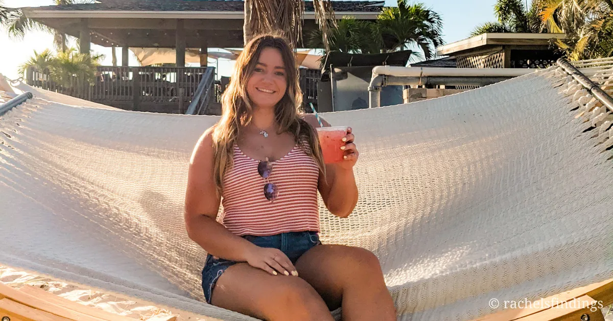 girl with mixed drink sitting on hammock