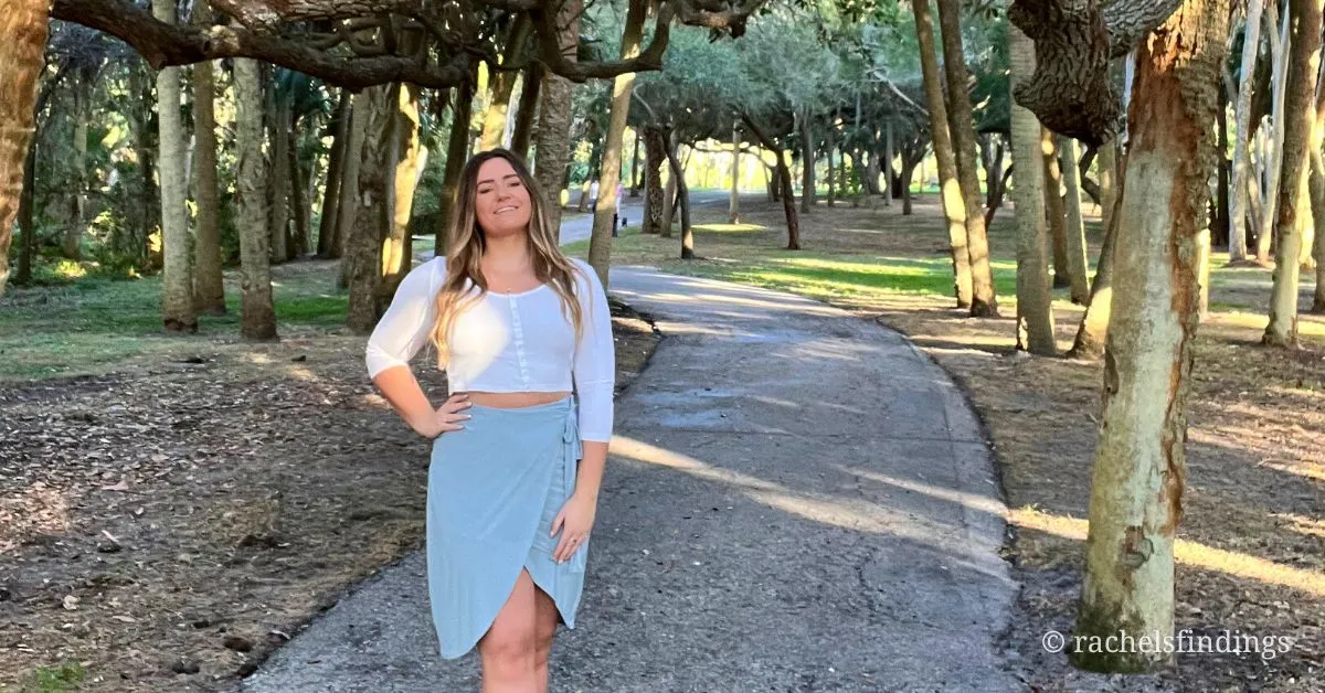 girl standing on pathway underneath mossy oak trees