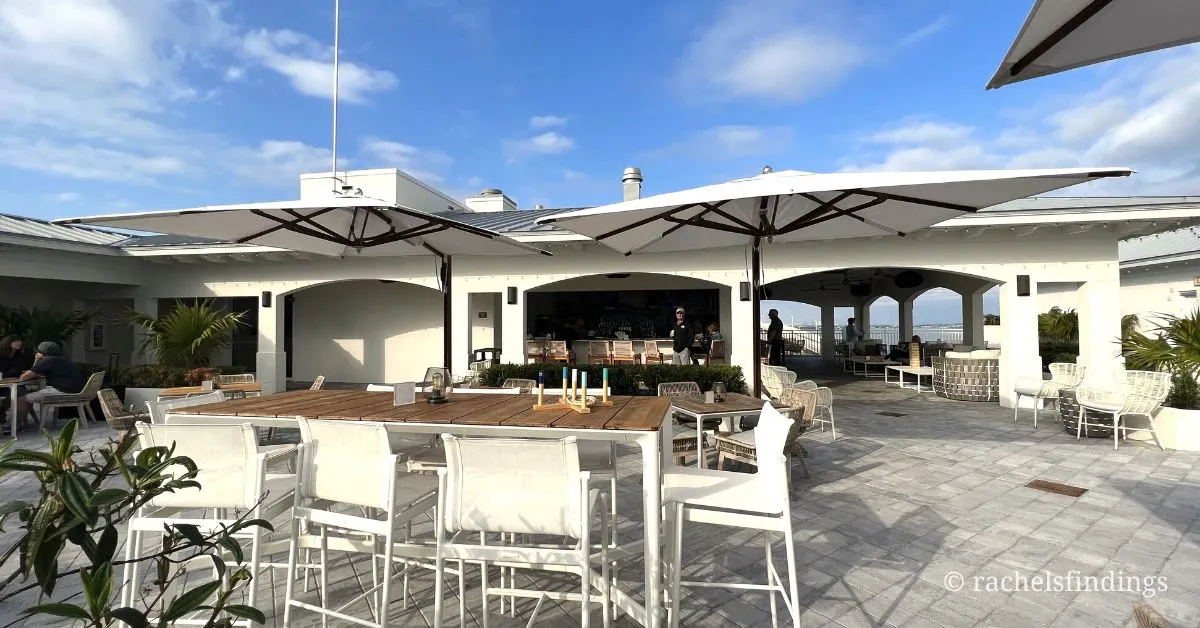 white tables and chairs on rooftop bar