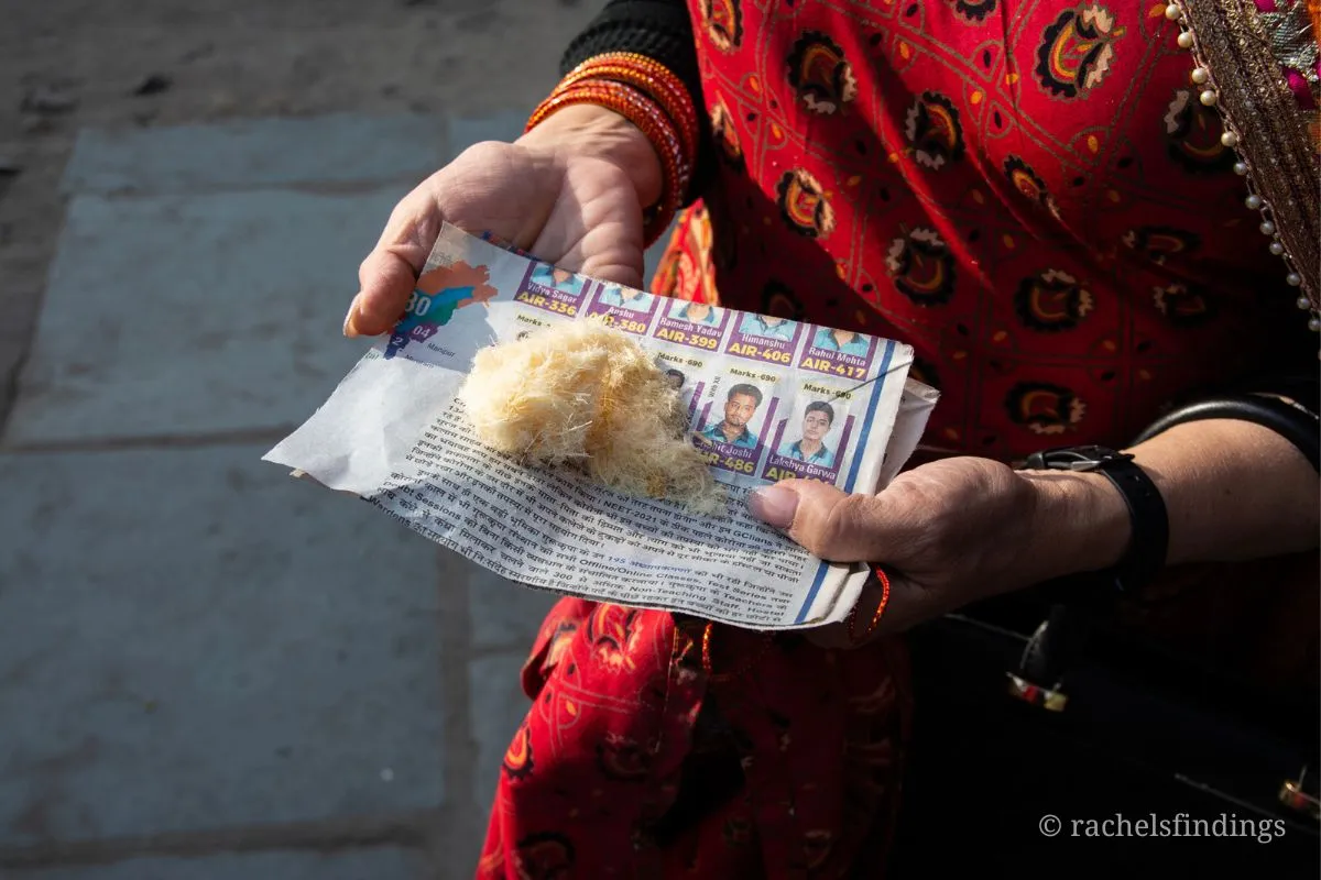 woman holding indian dessert