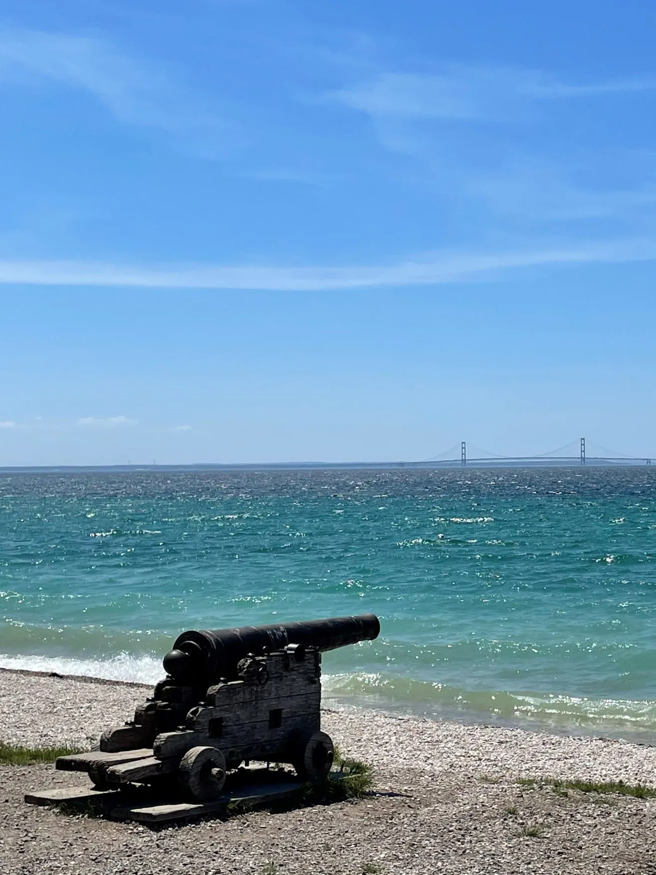 bristish landing beach on mackinac island with the mackinac bridge in the background