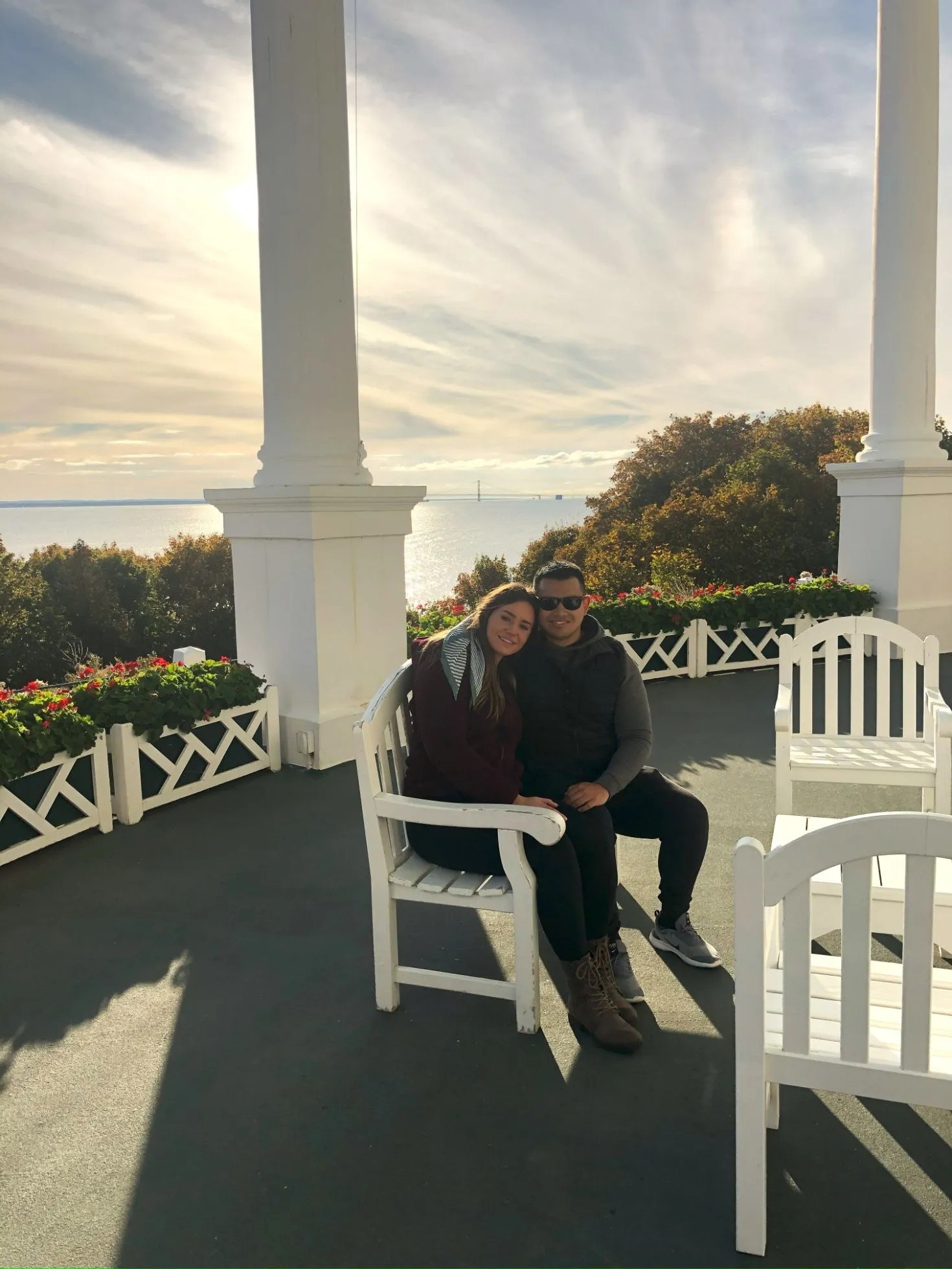 couple sharing a chair on the grand hotel mackinac island porch at golden hour