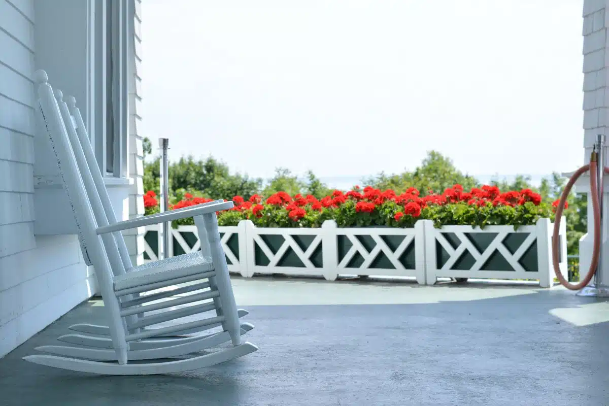 white rocking chairs with red flowers on grand hotel porch