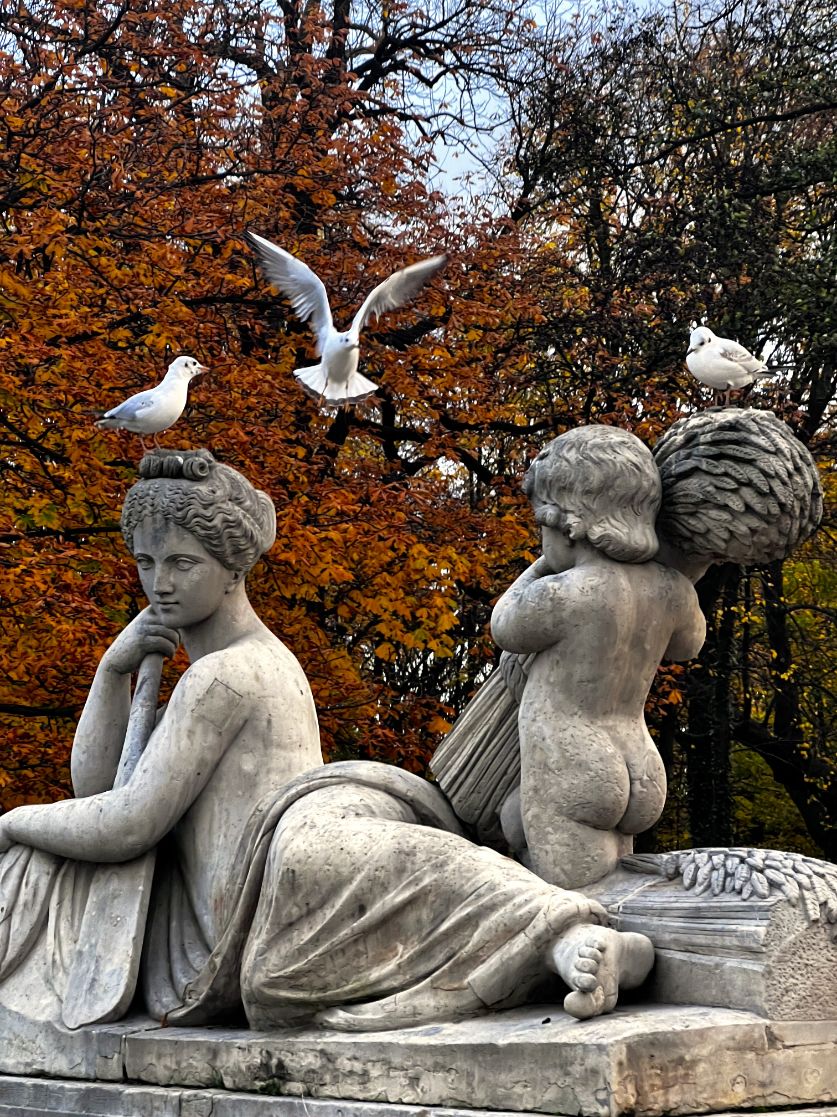 nude stone statues of kids in lazienki park