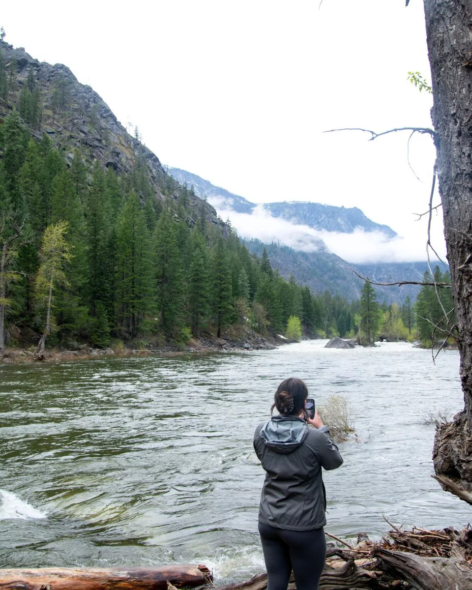 girl photographing wenatchee river near leavenworth wa